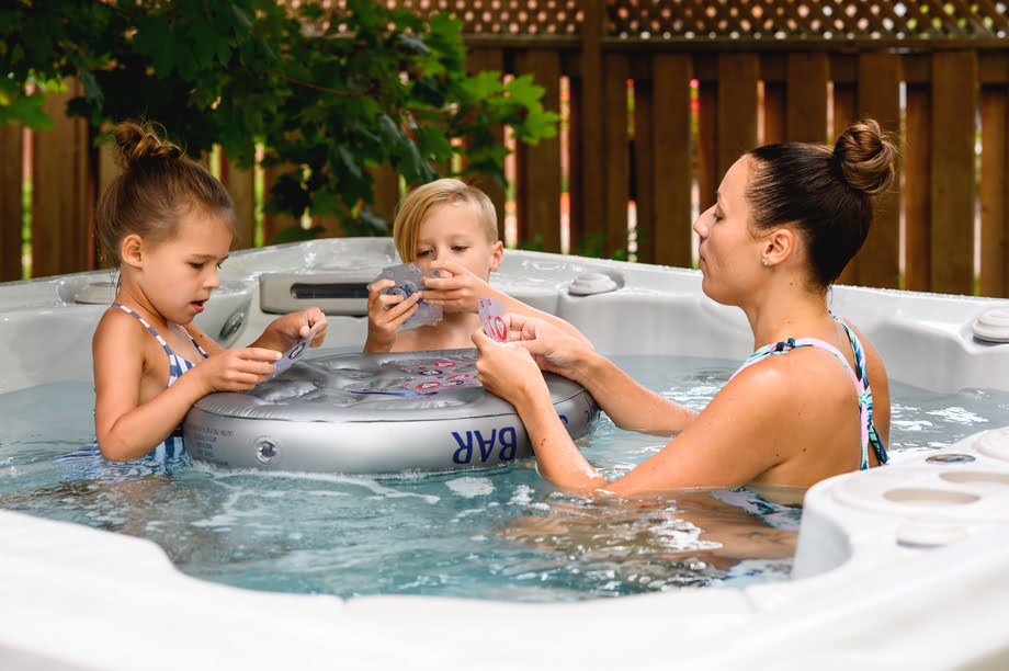 Une mère et ses enfants jouent aux cartes dans un spa. 